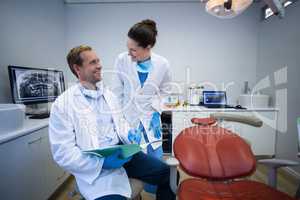 Dentists discussing on medical report in clinic