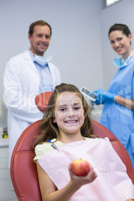 Portrait of smiling dentists and young patient