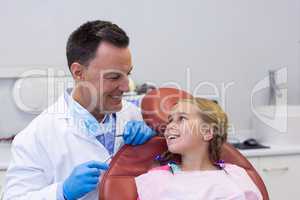 Dentist interacting with young patient