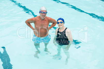 Senior couple standing in swimming pool