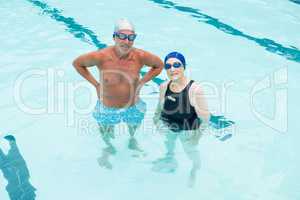 Senior couple standing in swimming pool