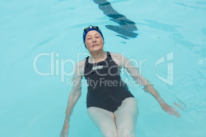 Senior woman swimming in pool