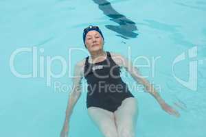 Senior woman swimming in pool