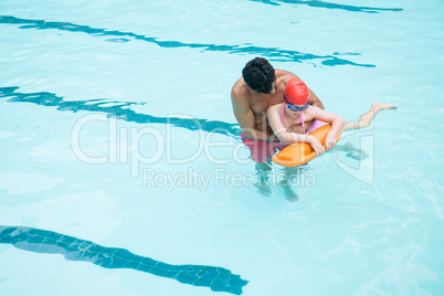 Lifeguard rescuing boy from swimming pool