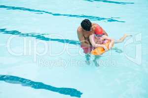 Lifeguard rescuing boy from swimming pool