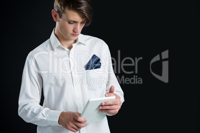 Androgynous man using digital tablet