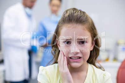 Unhappy young patient having a toothache in dental clinic