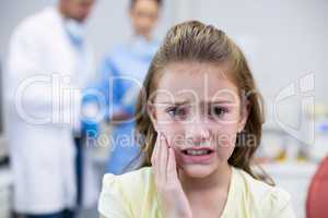 Unhappy young patient having a toothache in dental clinic