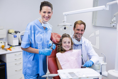 Portrait of smiling dentists and young patient