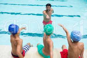 Coach and students taking oath in swimming pool