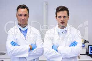 Portrait of dentists standing with arms crossed