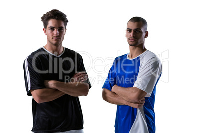 Two football players standing with arms crossed