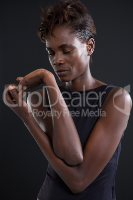 Androgynous man posing against grey background