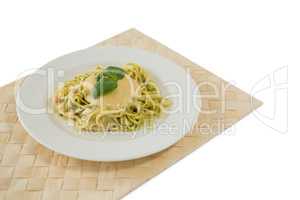 Close up of fettuccine served in plate on place mat