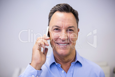 Dentist talking on mobile phone