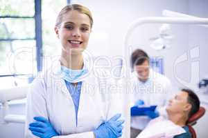 Portrait of smiling dentist standing  with arms crossed