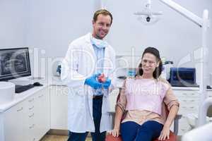 Portrait of smiling dentists and young patient