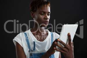 Androgynous man using digital tablet