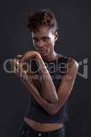 Androgynous man posing against grey background