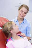 Mother interacting with daughter at dental clinic
