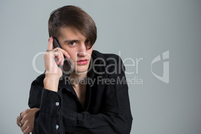 Androgynous man talking on his mobile phone