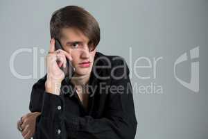 Androgynous man talking on his mobile phone