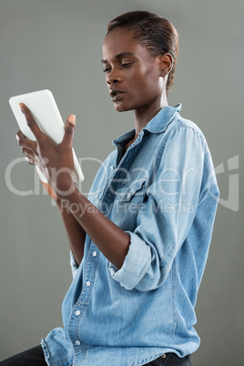 Androgynous man using digital tablet