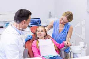 Dentist interacting with young patient