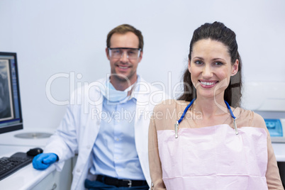 Portrait of smiling dentists and female patient