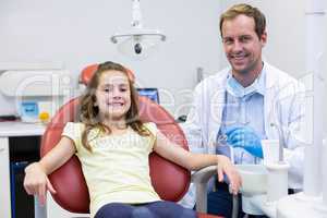 Portrait of smiling dentist and young patient
