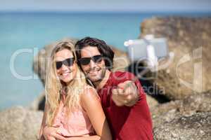 Couple taking selfie with monopod at beach