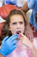 Dentist examining young patient
