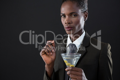Androgynous man holding a martini glass
