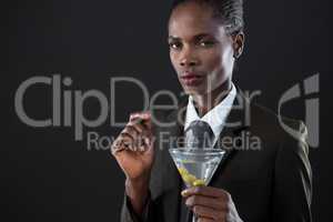 Androgynous man holding a martini glass