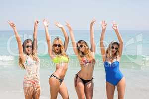 Female friends in bikinis enjoying at beach