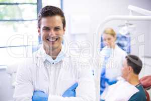 Portrait of dentist standing with arms crossed