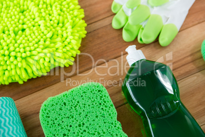 High angle view of chemical bottle with sponge and glove
