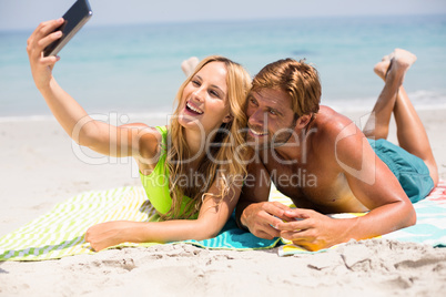 Couple smiling while taking selfie at beach