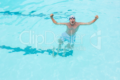 Excited senior man standing in swimming pool
