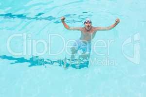 Excited senior man standing in swimming pool