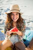 Happy woman having watermelon at beach
