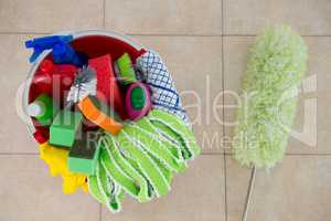 Overhead view of duster by various cleaning products in bucket