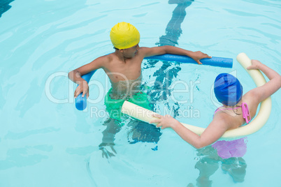 Two kids swimming in pool