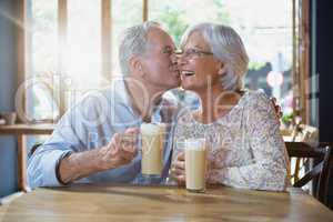 Senior man kissing senior woman