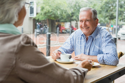 Senior couple sitting with coffee