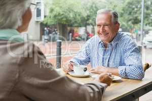 Senior couple sitting with coffee