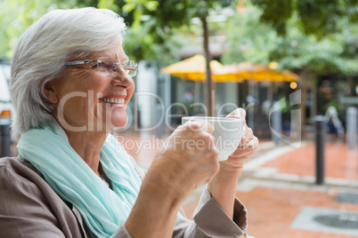 Senior woman holding a coffee cup