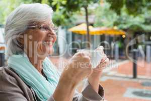 Senior woman holding a coffee cup