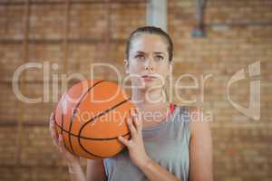 Determined girl holding a basket ball