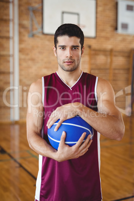 Determined basketball player holding a basketball